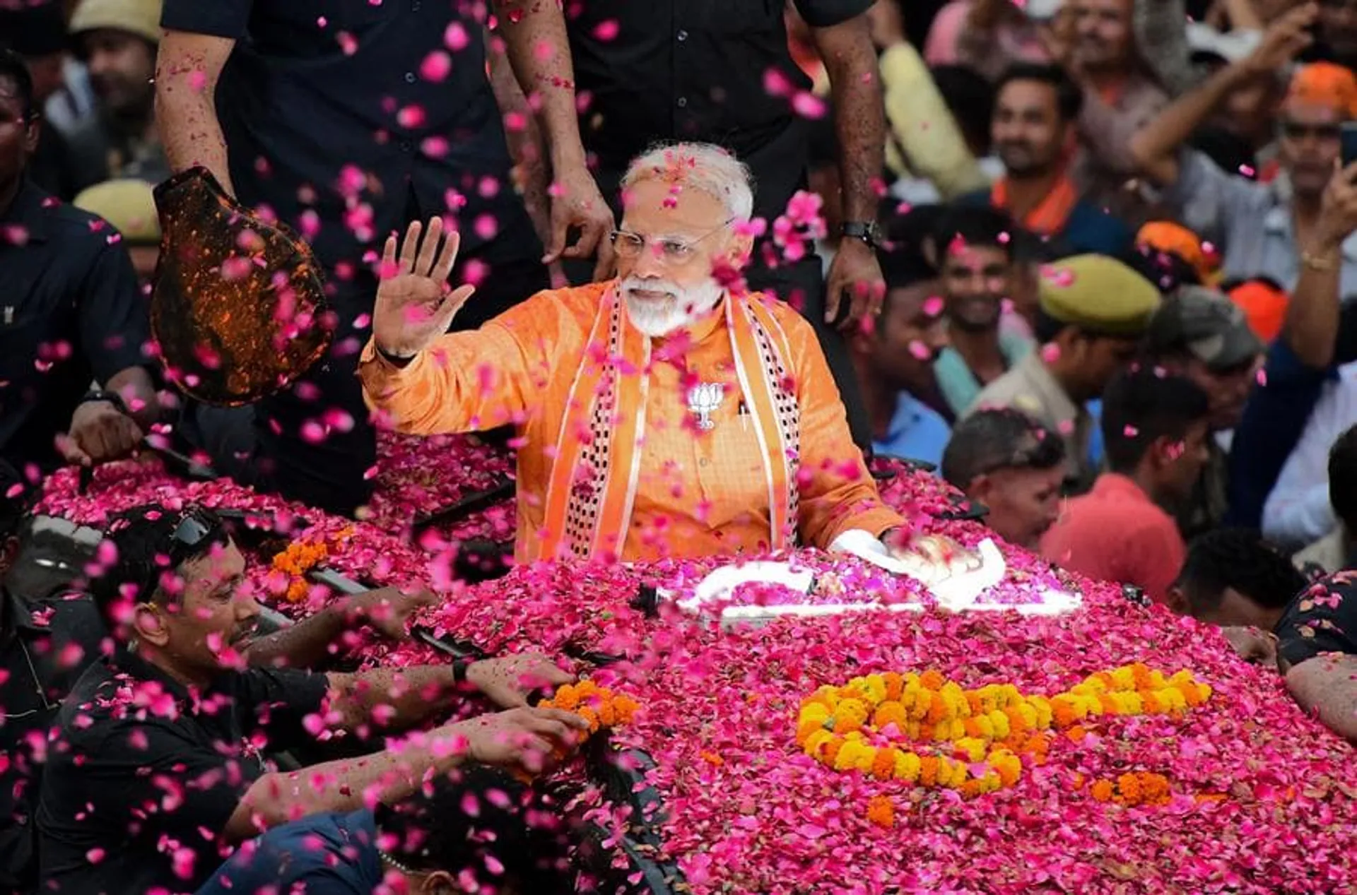 TOPSHOT - Indian Prime Minister and leader of the Bharatiya Janata Party (BJP) Narendra Modi gestures during a roadshow in Varanasi on April 25, 2019. - Tens of thousands of followers of Indian Prime Minister Narendra Modi packed the streets of his political bastion on April 25 as he stepped up campaigning in the country's marathon election. (Photo by SANJAY KANOJIA / AFP)        (Photo credit should read SANJAY KANOJIA/AFP/Getty Images)