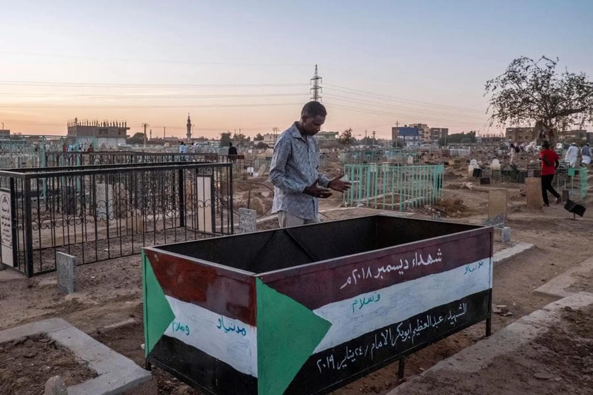 A man praying on the tomb of one of the Martyr of the Sudan's revolution at the Sheikh Hamed al-Nil cemetery where every Friday afternoon the Sufi meet to perform their dances and prayers near their leaders' tombs.