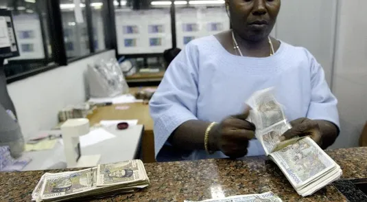 ABIDJAN, IVORY COAST:  An employee of the national agency of the BCEAO (Central Bank of West African States) collects a 1992-edition banknotes, 15 September 2004 in Abidjan, on the first day of the campaign to replace old banknotes with new ones across the eight countries of the Economic and Monetary Union of West Africa. Come January 1, some 850 billion CFA francs (1.3 billion euros) in bills from the 1992 series will no longer be considered legal tender in Senegal, Mali, Ivory Coast, Burkina Faso, Niger, Togo, Benin and Guinea-Bissau.   AFP PHOTO ISSOUF SANOGO  (Photo credit should read ISSOUF SANOGO/AFP/Getty Images)