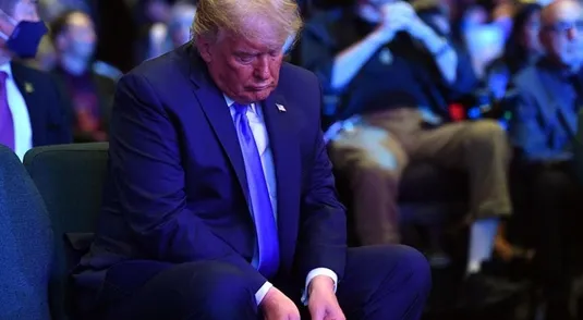 US President Donald Trump counts money before making an offering, as he attends services at the International Church of Las Vegas in Las Vegas, Nevada on October 18, 2020. - President Donald Trump and rival Joe Biden hit the ground Sunday in the swing states that will decide the US election, as the campaign turns increasingly vicious 16 days before voting. Trump, scrambling to make up lost ground, is on a furious multi-state barnstorming tour hopping from Nevada to California and then back to Nevada for a day of rallies and fundraising. (Photo by MANDEL NGAN / AFP) (Photo by MANDEL NGAN/AFP via Getty Images)